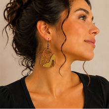Cargar imagen en el visor de la galería, Model wearing Bag & Heels 3D wooden earrings with a simple black top and hair pulled back.