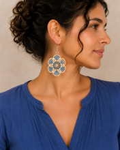 Cargar imagen en el visor de la galería, Model wearing Blue Blossom embroidered wooden earrings with a blue blouse and hair pulled back.