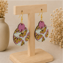 Cargar imagen en el visor de la galería, Angled view of Boho Chic Butterfly wooden earrings on a light wood stand.