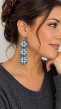 Cargar imagen en el visor de la galería, Model wearing Frozen Sky lightweight layered snowflake wooden earrings with silver-tone hooks