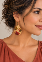 Cargar imagen en el visor de la galería, Model wearing lightweight Leaf Whispers engraved wooden earrings with a soft brick top