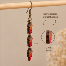 Cargar imagen en el visor de la galería, Side view of Autumn Ember wooden earrings showing the 2 mm wood thickness and layered leaf construction.
