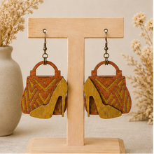 Cargar imagen en el visor de la galería, Bag &amp; Heels 3D wooden earrings displayed front-facing on a light wood stand.
