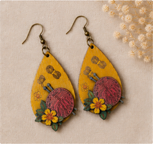 Cargar imagen en el visor de la galería, Hooked on Crochet wooden earrings arranged flat on a neutral surface, showing the full front design and antique-bronze hooks.
