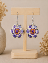 Cargar imagen en el visor de la galería, Lavender Bloom hand-embroidered wooden earrings displayed front-facing on a light wood stand.
