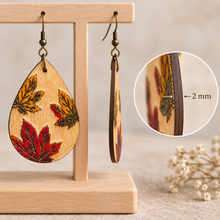 Cargar imagen en el visor de la galería, Side view of Leaf Whispers wooden earrings showing the single-piece 2 mm American linden wood construction
