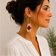 Cargar imagen en el visor de la galería, Mauve Blossom wooden earring worn with a warm ivory blouse, shown at a more realistic scale.
