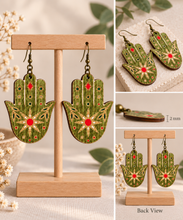 Cargar imagen en el visor de la galería, Mystical Hamsa Hand wooden earrings shown in detail with engraved motifs, 2 mm wood thickness, and double-sided design
