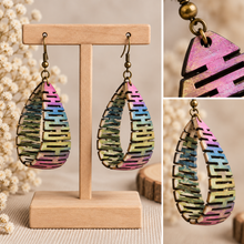 Cargar imagen en el visor de la galería, Pearlescent Rainbow wooden earrings shown in detailed angled views highlighting the curved open construction and hand-painted finish
