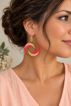 Cargar imagen en el visor de la galería, Model wearing SunTwist Joy lightweight wooden swirl earrings in coral, peach and olive with a pale peach top and gold-tone hooks
